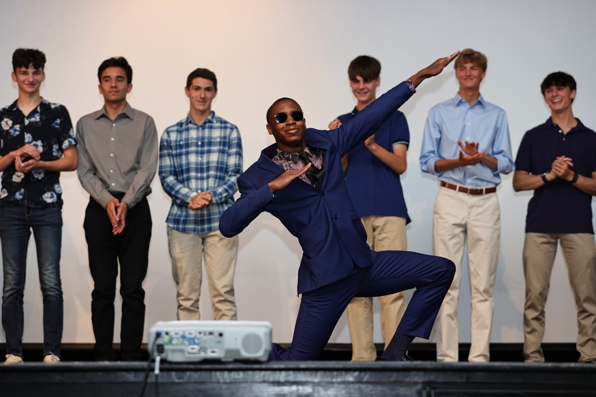 Track student poses on stage during spring varsity awards at CHS.