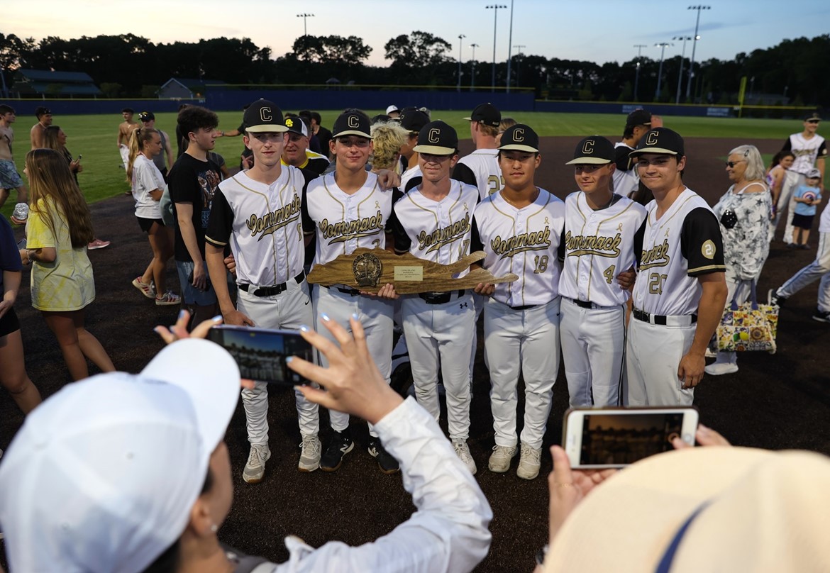 Baseball players pose with Long Island championship award.