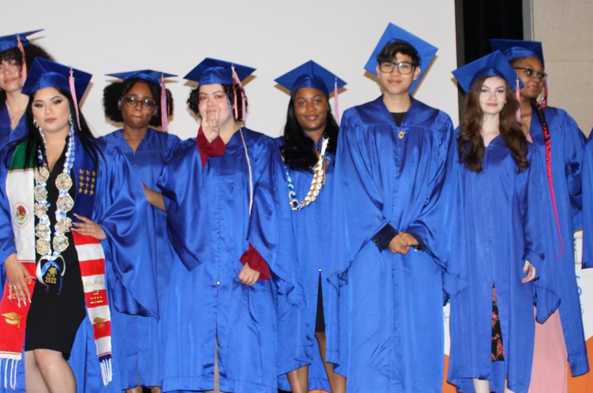A group of Compass scholars at graduation in their blue cap and gowns