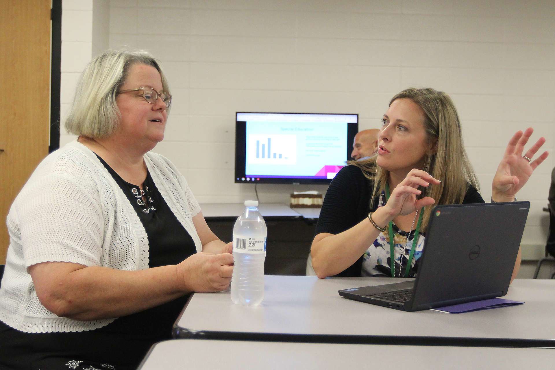 Jennifer Davis listening to a staff member