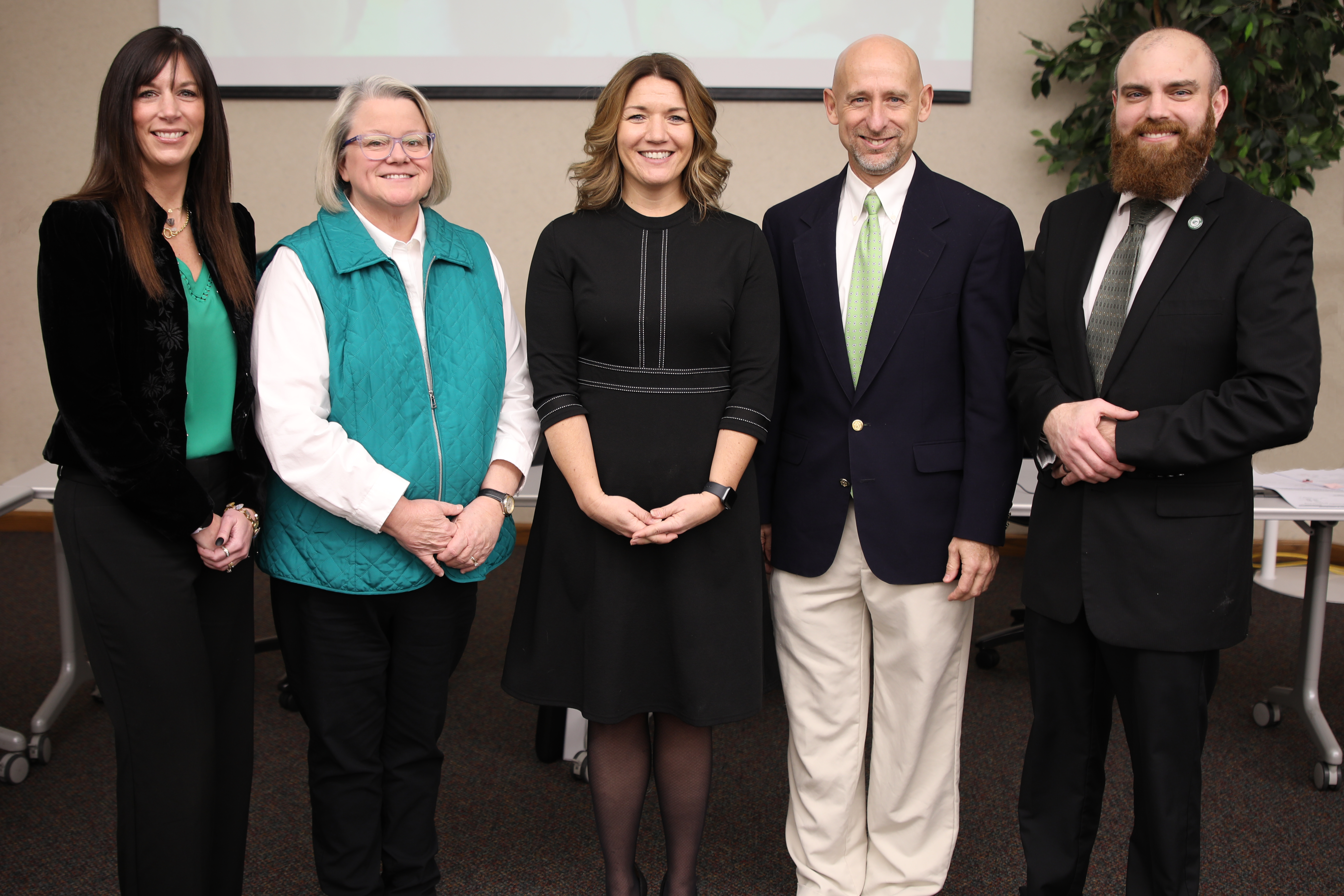Five school board members pose for a picture