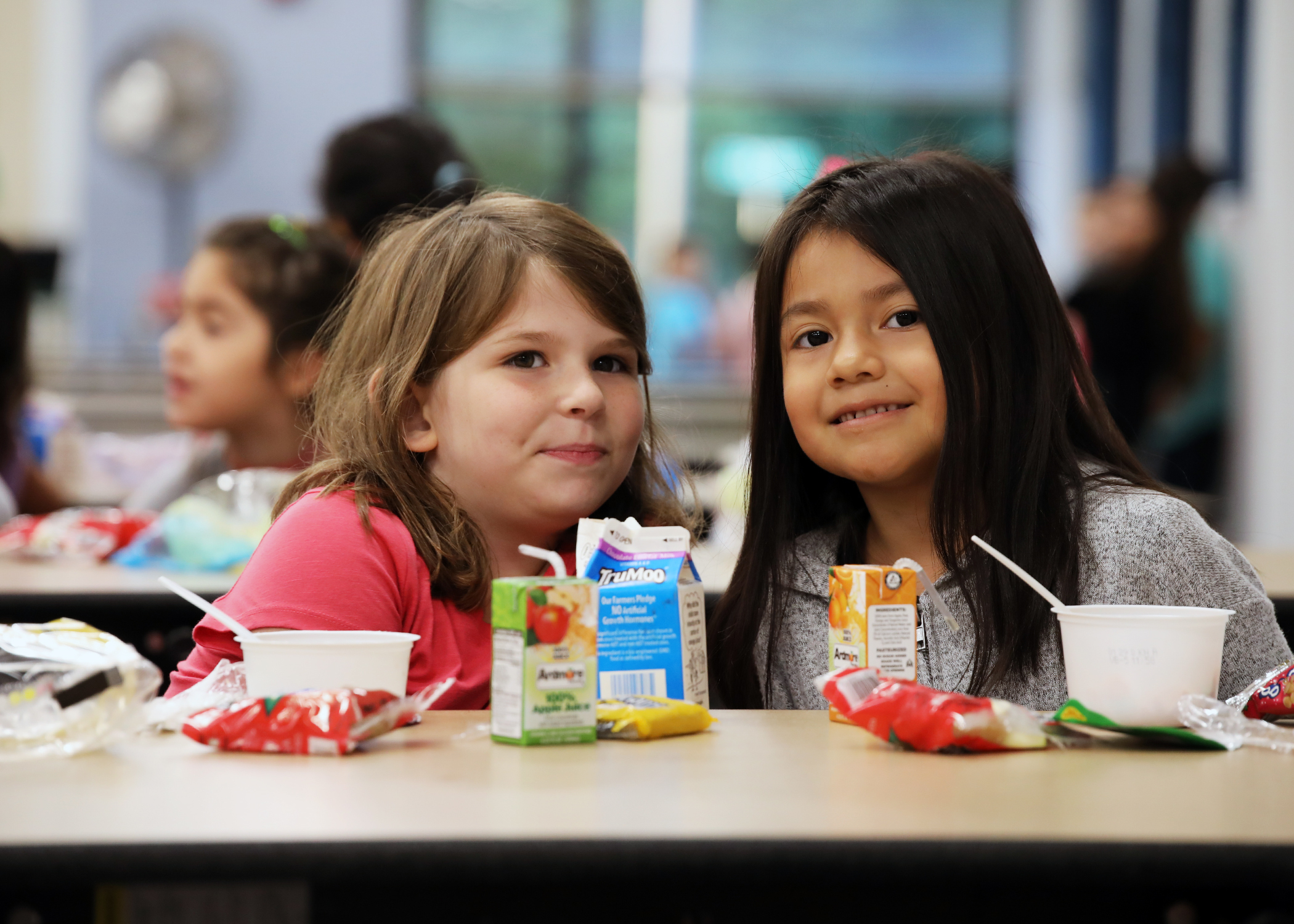 Children posing for a picture in the cafeteria