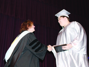 Destinations graduate Ashton Beltran is congratulated by Coos Bay Schools Superintendent Charis McGaughy.