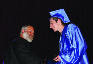 Resource Link graduate Markus Walker is congratulated by School Board member Kevin Dubisar.