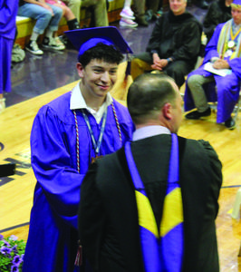 Junior Ybarra accepts his diploma during graduation ceremonies Saturday.