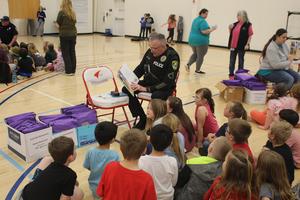 Officer Scoville reading to students