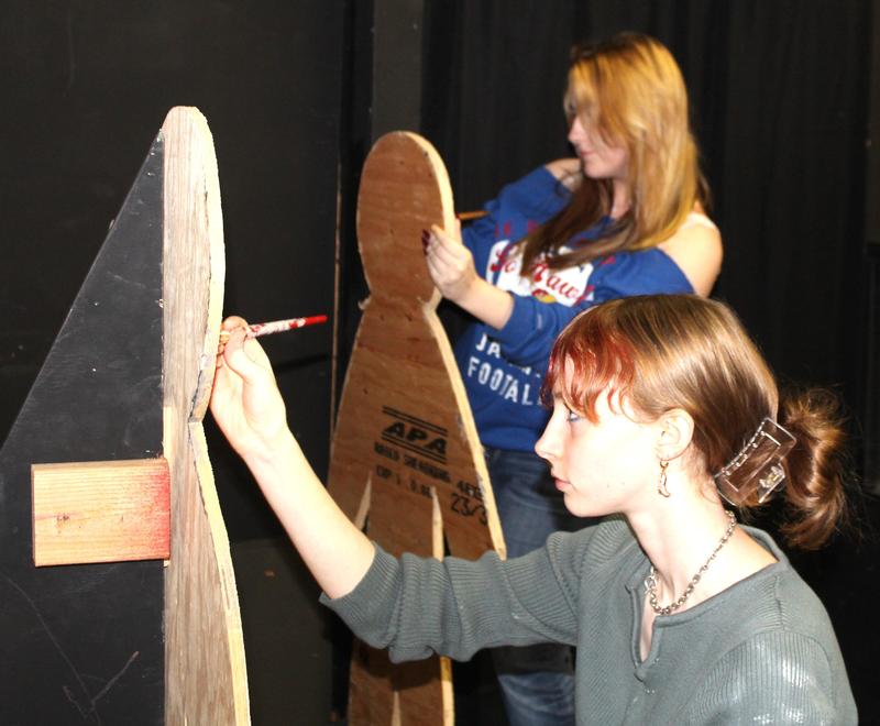 Ellajane Brigham, front, and Gracelyn Hamner paint props while preparing a haunted house that will open in the Marshfield High School Drama Lab on Friday.