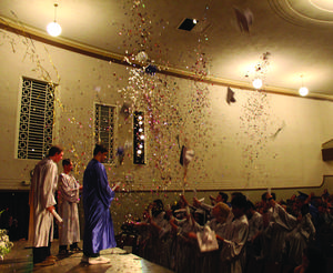 Graduates from Destinations Academy and Resource Link Charter School celebrate by throwing their caps and shooting off poppers at the end of their graduation ceremony Thursday.
