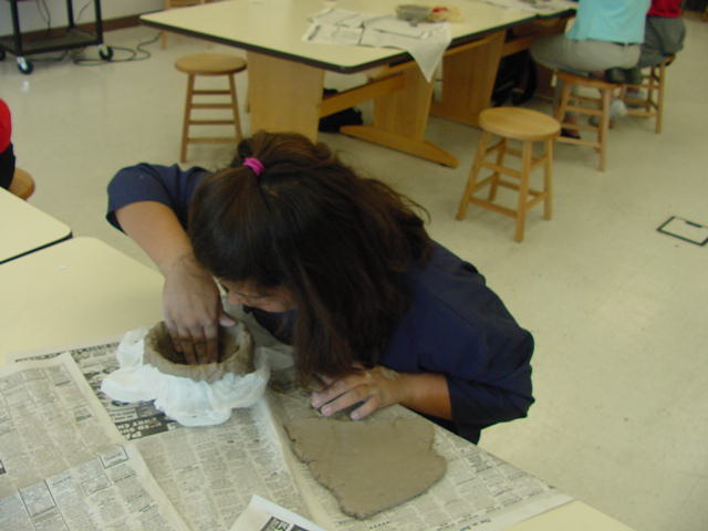 kid molding clay bowl