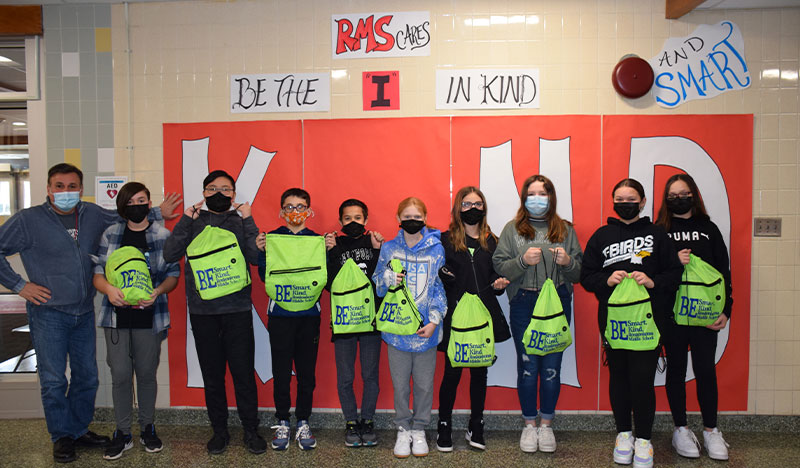 The Ronkonkoma Middle School student council each holding their lime green bag