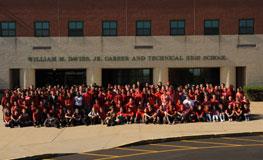 a class photo in front of the school