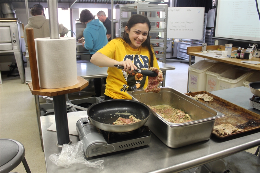 Culinary students prepare chicken carnitas