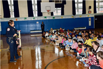 Gotham Avenue School students watching officer speak thumbnail264373