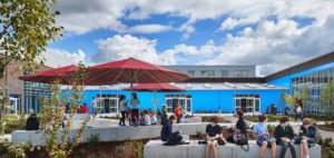 Students enjoy the courtyard during a moment of sunshine at the new Roosevelt Middle School building. Photo courtesy of Mahlum Architects Inc.