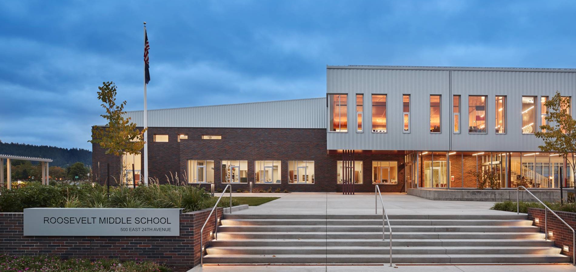 The front of the new Roosevelt Middle School building, lit up at twilight. Photo courtesy of Mahlum Architects Inc.