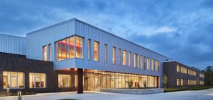 Entry to the new Roosevelt Middle School building, lit up at twilight. Photo courtesy of Mahlum Architects Inc.