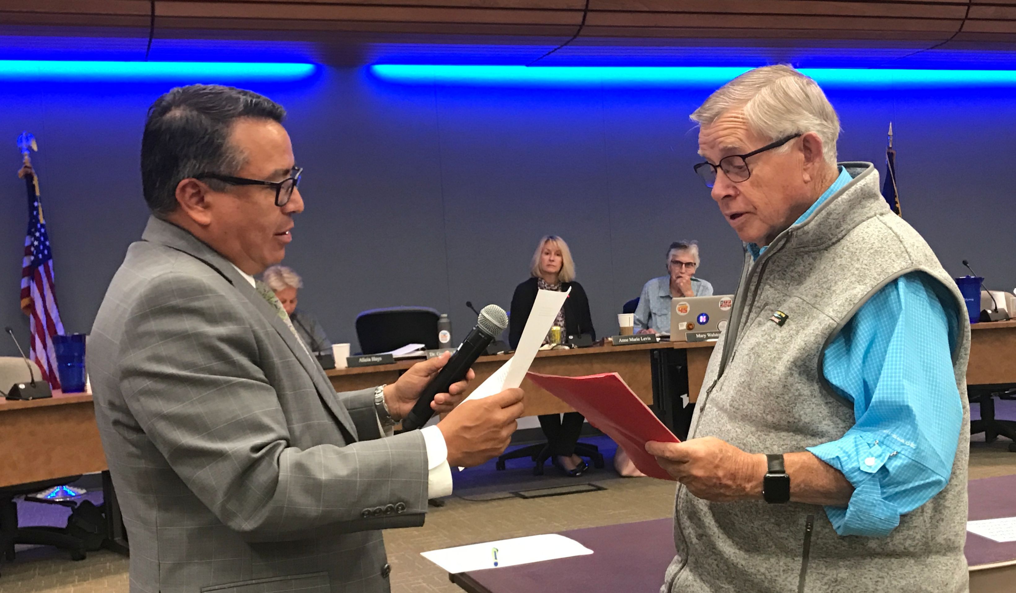 Superintendent Gustavo Balderas administers the oath of office to board member Jim Torrey