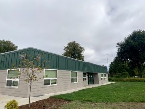 Photo of ECCO's new school building next to the rose garden