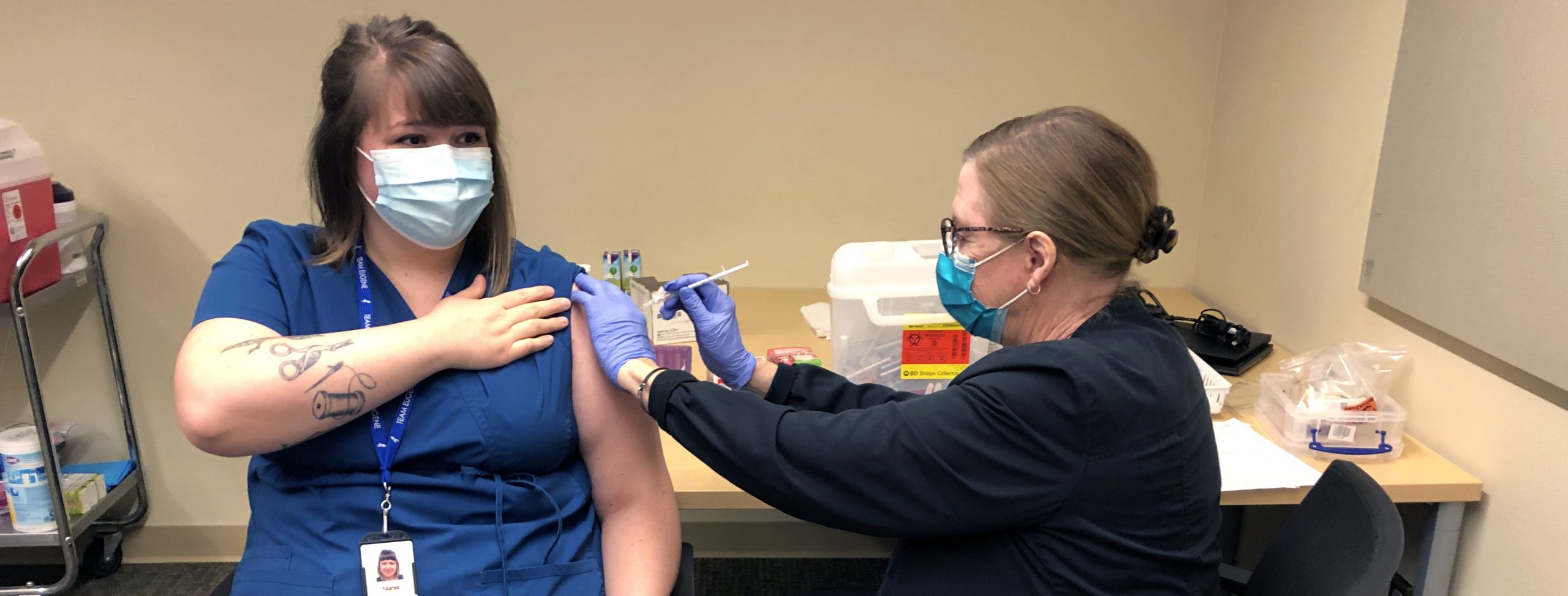 A 4J school nurse gets a COVID-19 vaccine shot in January 2021