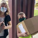 Youth picking up school meal boxes