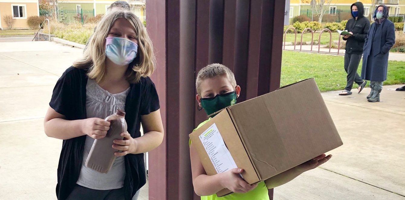 Youth picking up school meal boxes