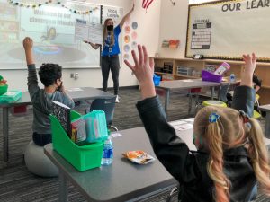 Students and teacher in classroom, following health and safety protocols