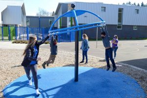 Students playing on playground at recess, following health and safety protocols