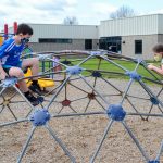 Students play on playground at recess, following health and safety protocols