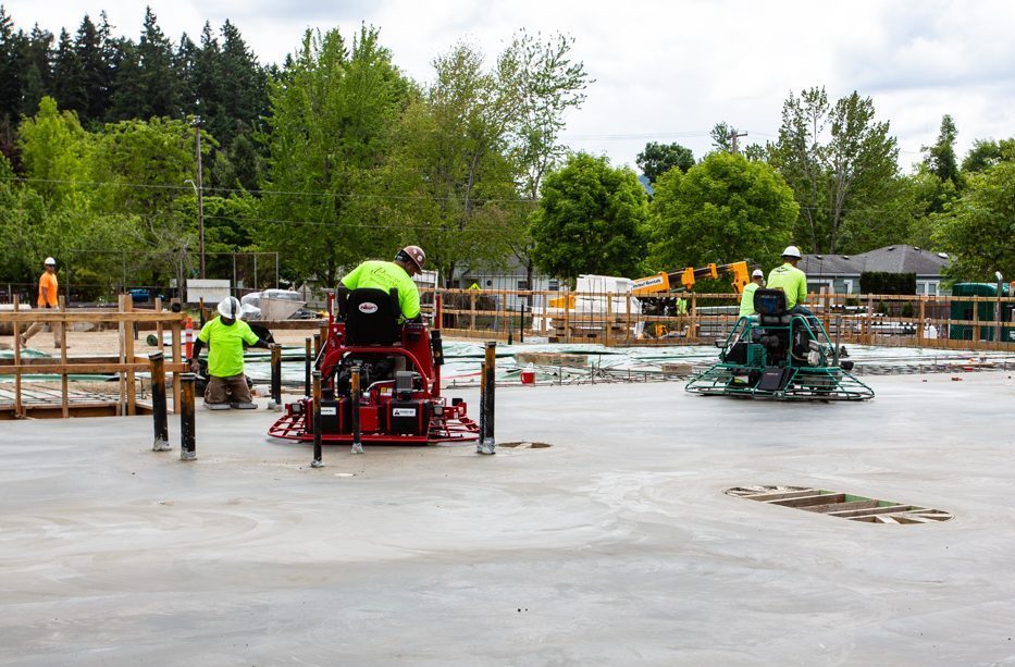 Edison update: a closer look at workers drying the new concrete slab.