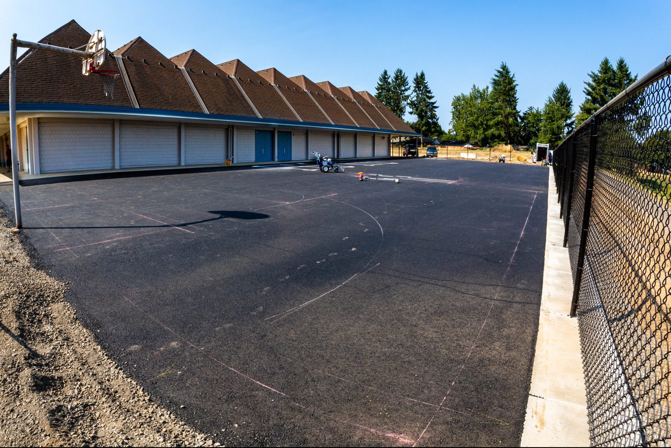 Chinese Immersion Renovation: in-progress view of the new basketball court and security fencing at the rear of Kennedy Middle School.