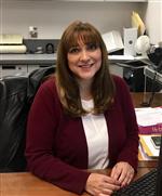 Image of Ms. Cardona at her desk.  
