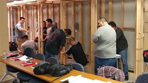 Students helping each other while working inside frames.  