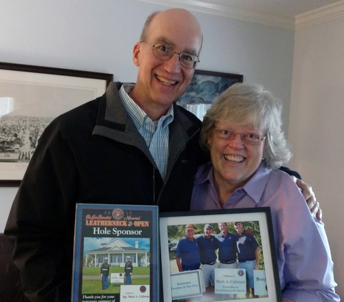 Terry and Annie Callanan hold the plaques Coach Fitch and Coach Longhouse presented them with in honor of their son, Mark, on Oct. 25.