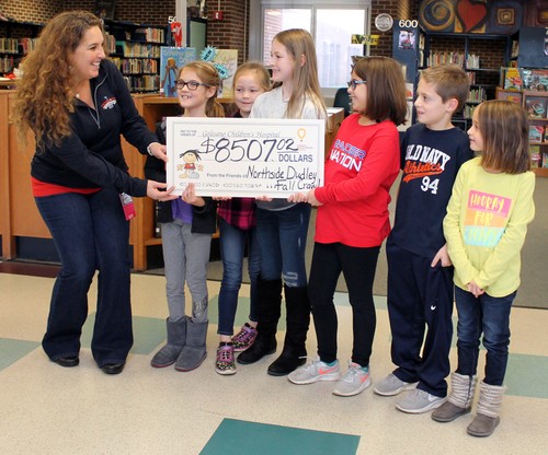 Students present Stephanie Sheets, of Golisano, with the donations from the Fall Crawl.