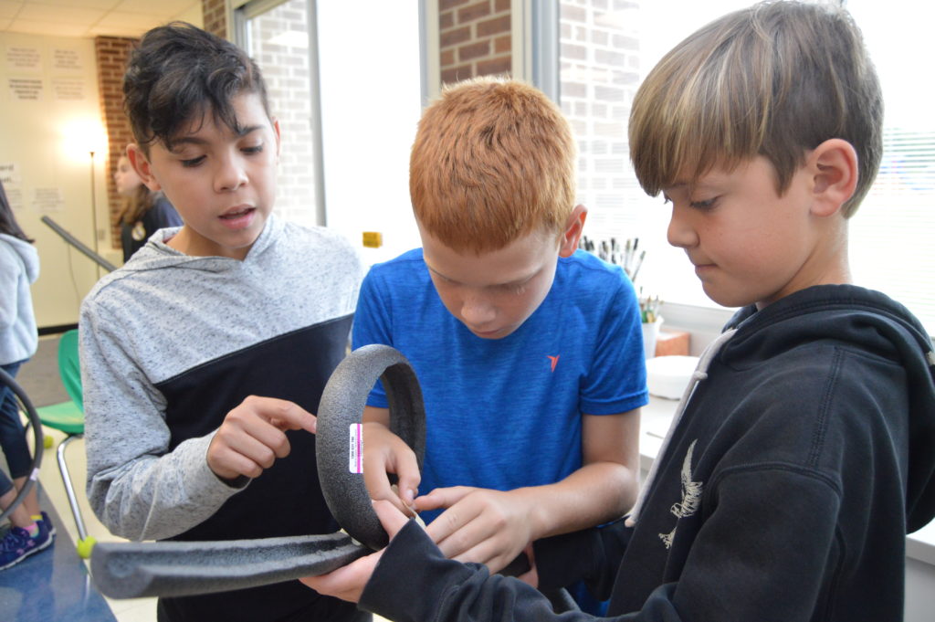 Three students cooperatively working