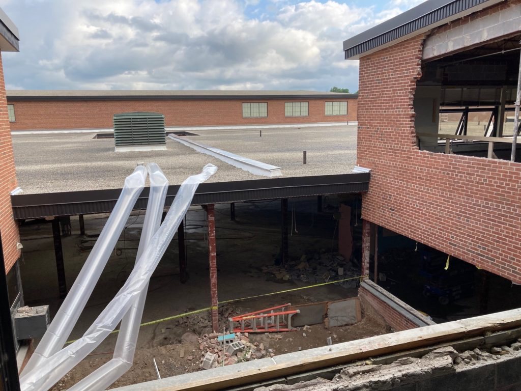 A view of the roof of Fairport High School with demolition equipment