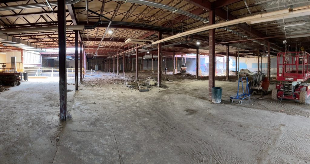 corner view of a demolished indoor space with bare beam supports