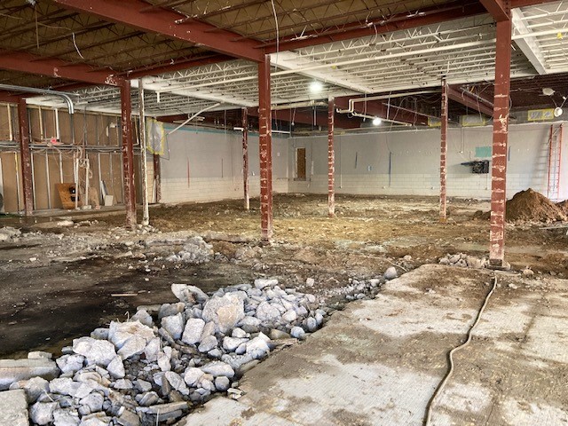 Demolition and removal of flooring material from a construction site