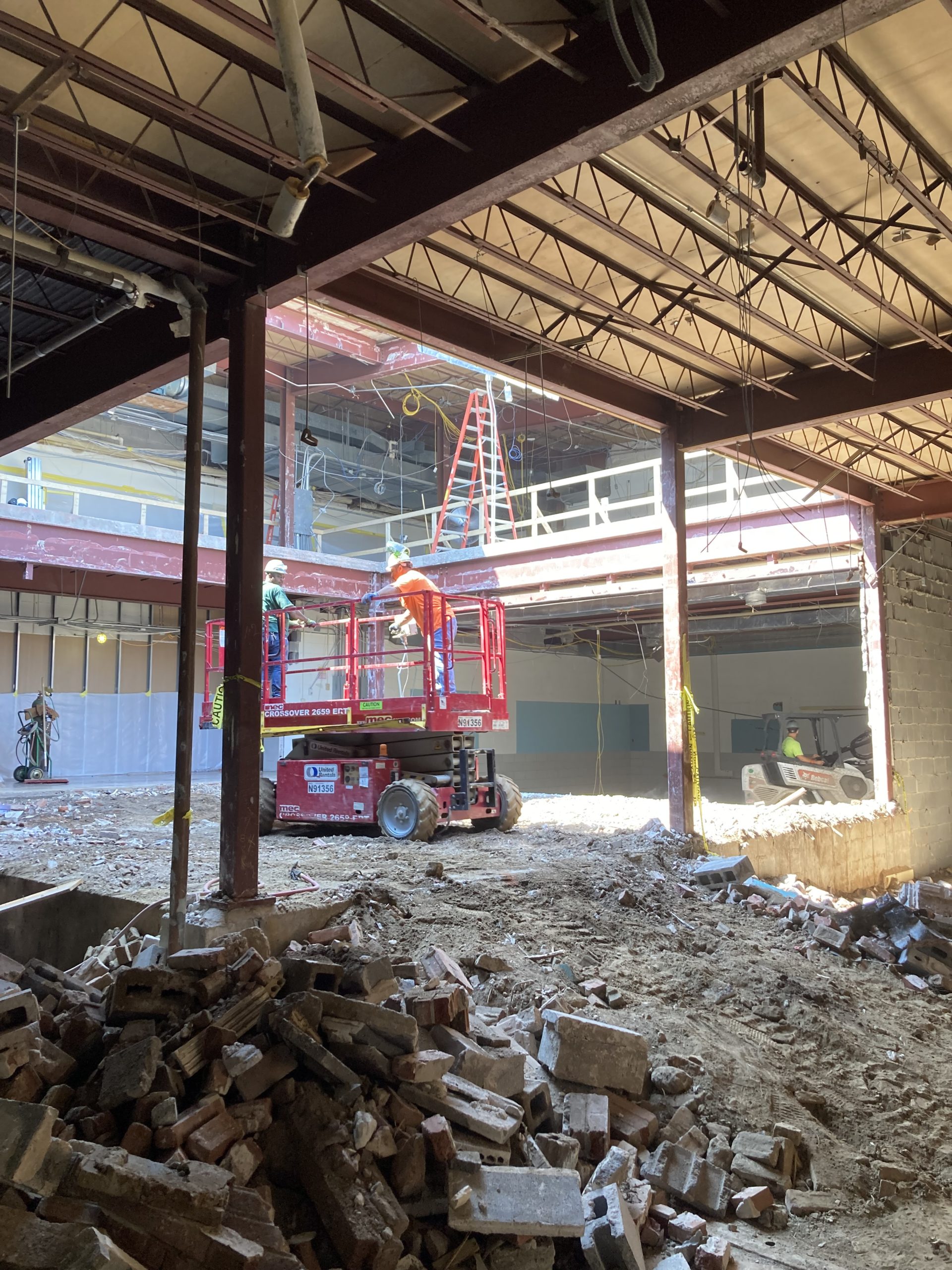 construction equipment surrounded by demolished walls inside a courtyard