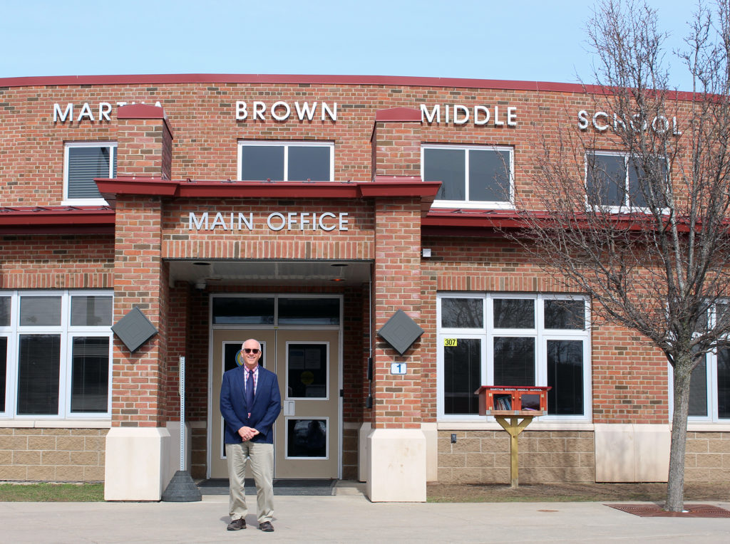 Dave Dunn stands in front of Martha Brown Middle School