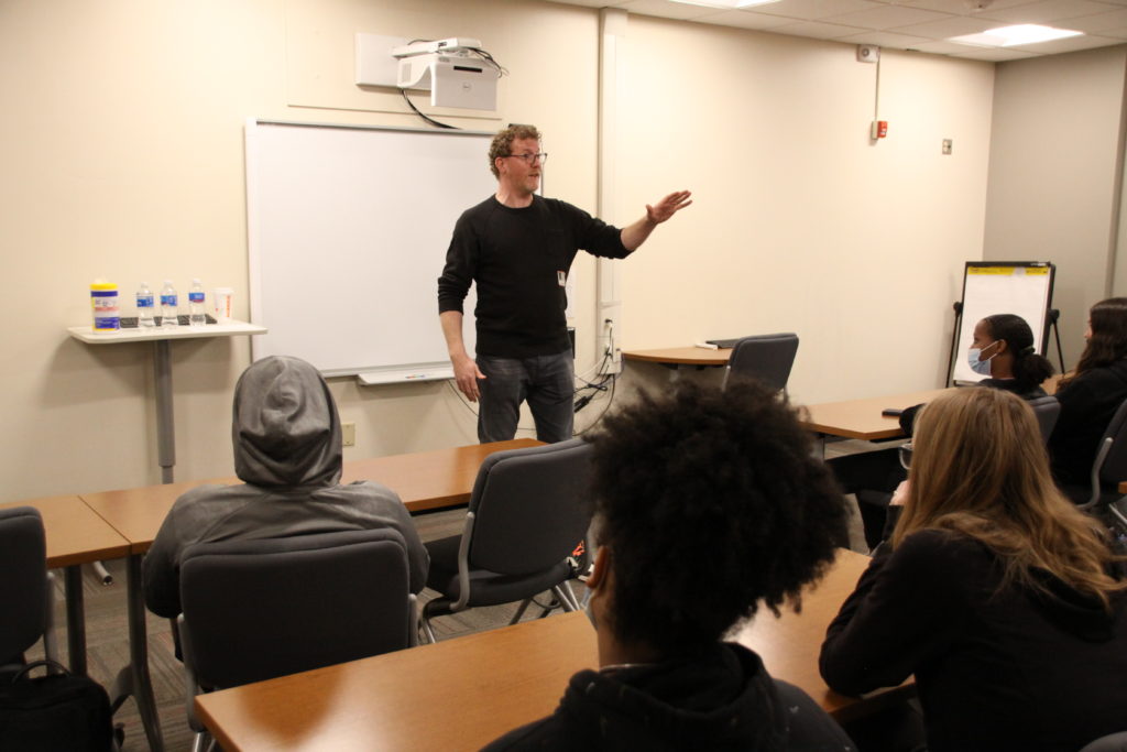 Author Brendan Kiely speaks in front of a room full of FHS students