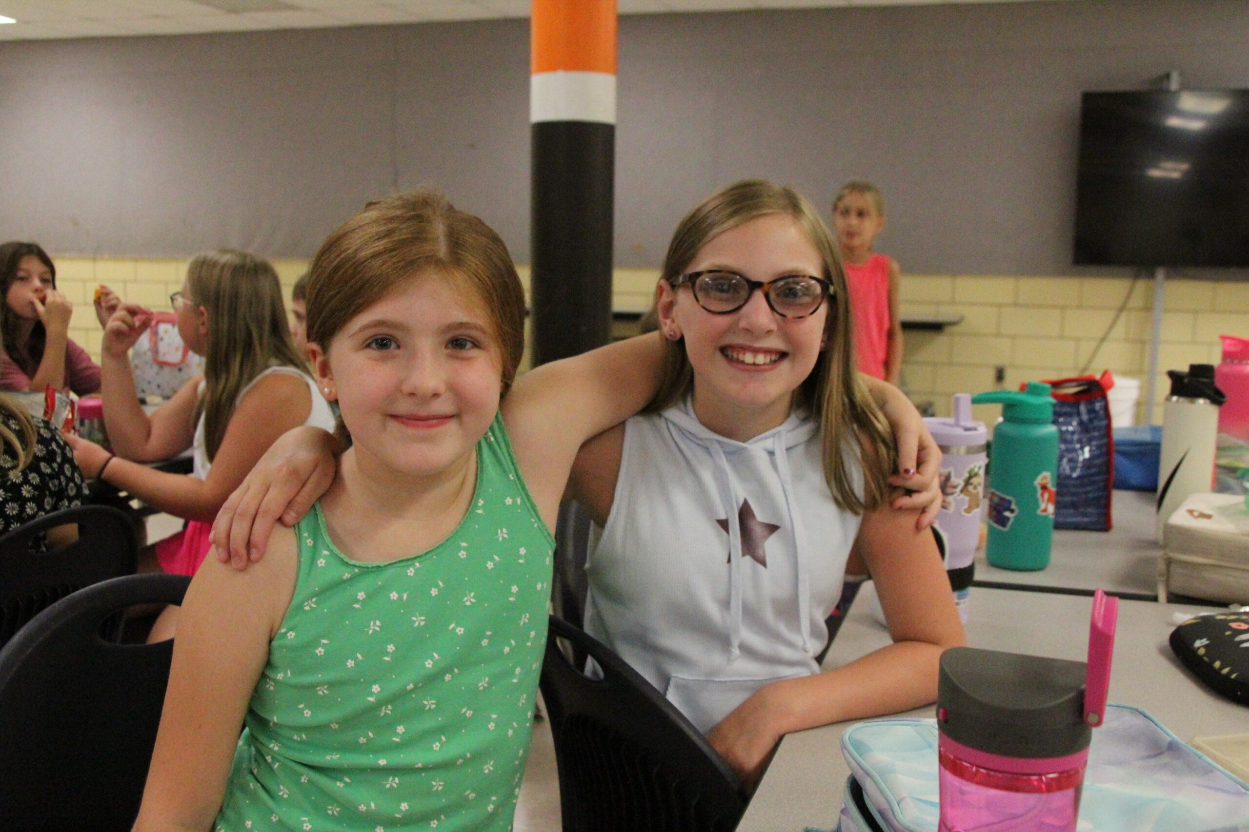 Two elementary school students smile at the camera