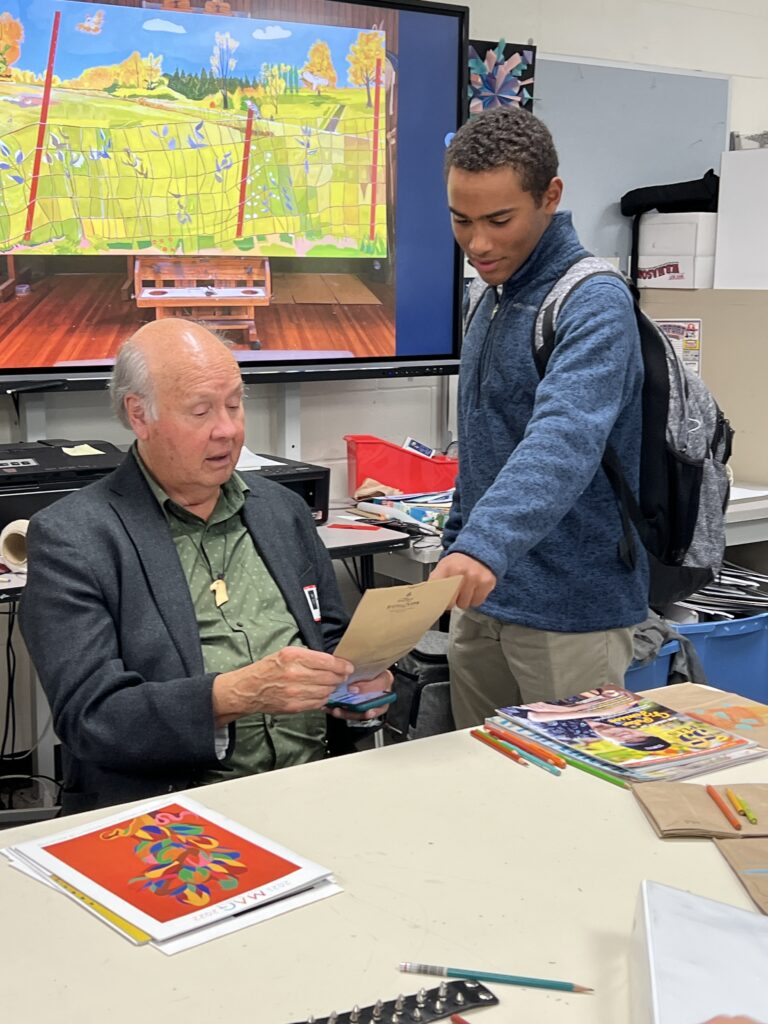 Artist G. Peter Jemison looks at an art piece created by a student.