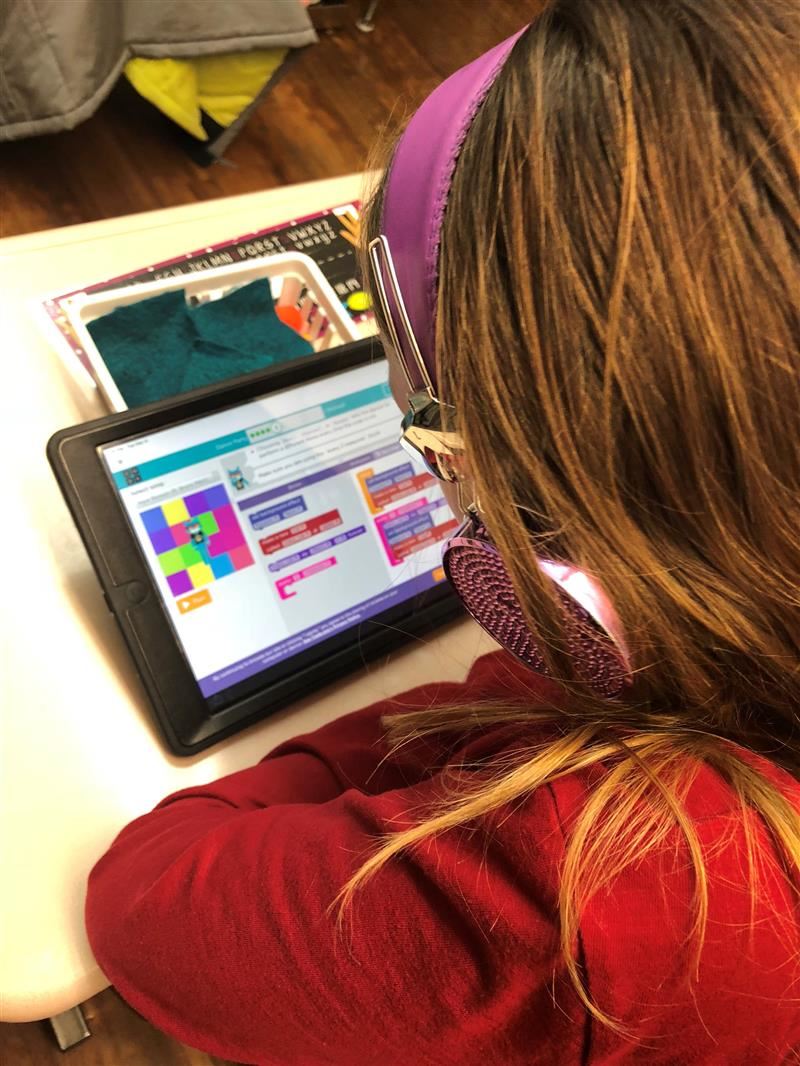 Student using iPad with headphones on