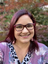 Head shot of woman smiling.