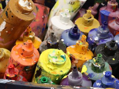  cluster of paint bottles splattered with paint