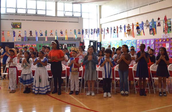 Freeport Public Schools’ Leo F. Giblyn Elementary School came alive with its lively celebration of global cultures on May 15 during its annual International Day luncheon. The school’s fourth grade tradition honors the rich cultural backgrounds of Giblyn students and staff while inspiring messages of acceptance, resilience and unity.   This year’s event was themed around the quote, “Every mountain top is within reach if you just keep climbing” – Barry Finlay, a message that resonated as students delivered heartfelt reflections on overcoming obstacles, embracing their heritage and finding strength in their differences.   Principal Amy Lederer welcomed students, staff, board of education members and district leaders to the celebration. “Our differences make us stronger,” she said. “When we come together to learn about and uplift one another’s cultures, we grow as individuals and as a community.”   The event featured beautiful performances from the fourth grade step team and a special performance of a reggaeton dance by members of the dance team. Under the direction of music teacher Shannon Abramovitz, the fourth grade students sang two songs the first song reinforcing the power of coming together as one, “In this World Together,” by Teresa Jennings and the second the traditional Mexican celebratory song, “Las Mañanitas.”    In recognition of outstanding dedication to celebrating and promoting cultural diversity, the 2025 Mary Johnson International Day Award was presented to Mrs. Anita Stevenson. A dedicated member of the Giblyn staff, Mrs. Stevenson was honored for her passion, commitment and efforts to make all students feel valued.   The celebration concluded with a much-anticipated international food tasting, where students enjoyed traditional dishes from countries including India, Greece, the Dominican Republic, Mexico, Italy and Poland. Dressed in cultural attire and beaming with pride, students and staff embraced the day’s spirit of honoring heritage and moving forward to reach new heights.  