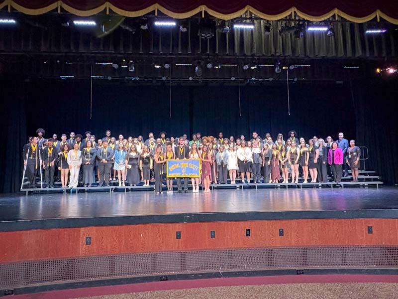 Students on stage receiving awards.