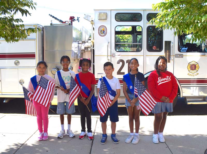 From left, Freeport Public Schools Assistant Superintendent for Curriculum and Instruction Dr. Anthony Murray, Executive Director for Personnel Dr. Marie Gabaton-Swift, Interim Superintendent of Schools Dr. Alice Kane, members of the Freeport Fire Department and New Visions Elementary School Principal Jessica Romero on Sept. 11, 2025. From left, Freeport Public Schools Assistant Superintendent for Curriculum and Instruction Dr. Anthony Murray, Executive Director for Personnel Dr. Marie Gabaton-Swift, Interim Superintendent of Schools Dr. Alice Kane, members of the Freeport Fire Department and New Visions Elementary School Principal Jessica Romero on Sept. 11, 2025.