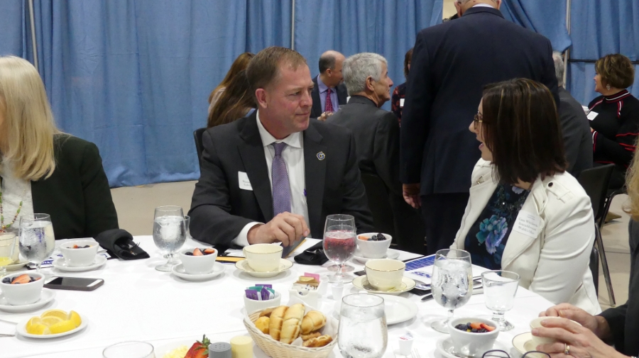 Superintendent Shine talks with a representative from Assemblywoman Walsh's office.